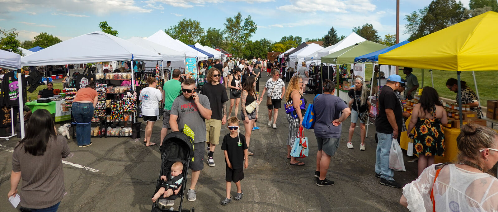 Shoppers browsing the market row on a Thursday evening at Carpenter Park